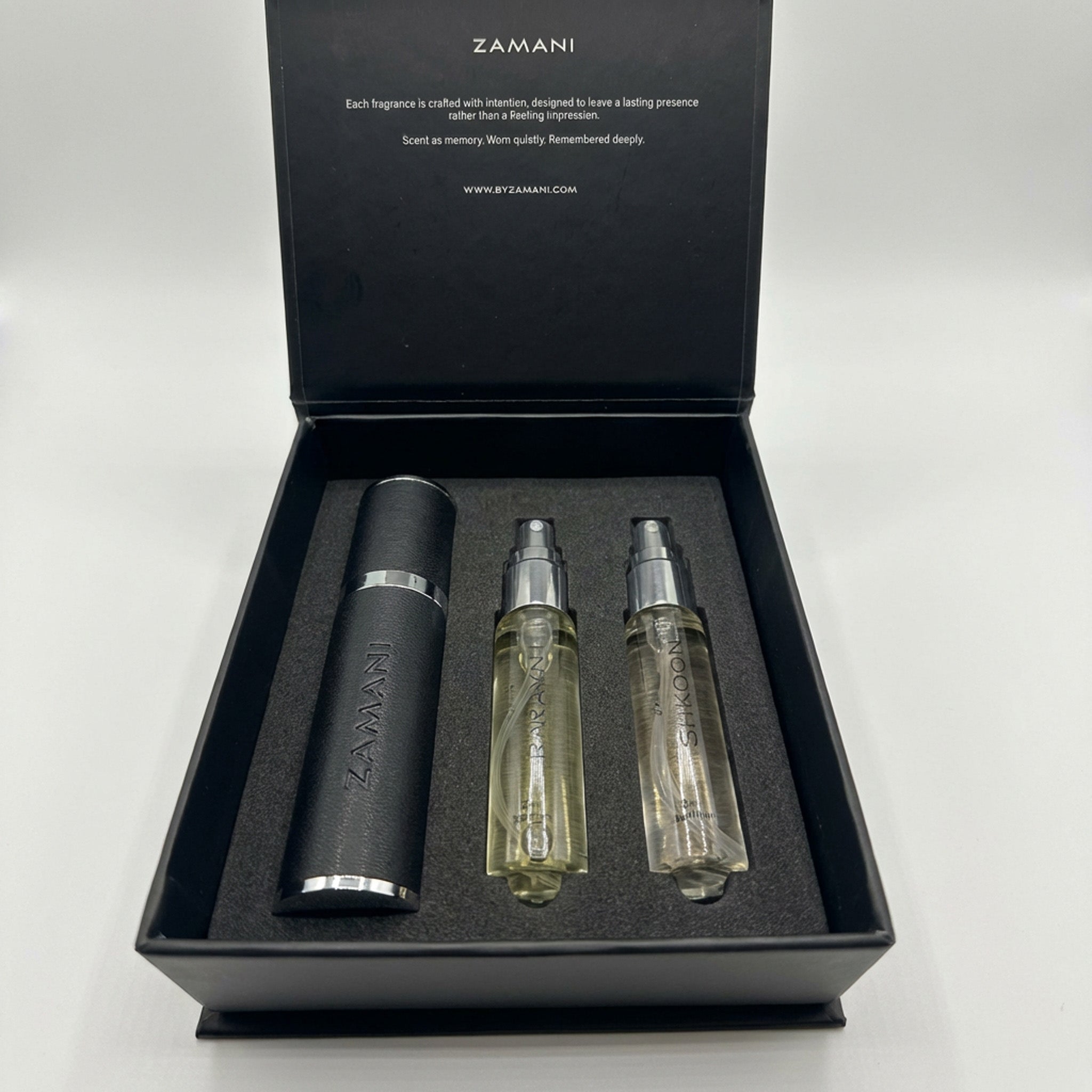 Zamani perfume set with a black bottle and two spray bottles in a box on a white background